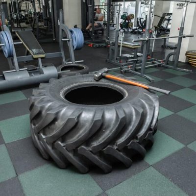 large-wheel-with-heavy-hammer-modern-gym-fitness-equipment-cross-functional-training_175682-27022